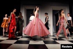 FILE - Models present creations during the Monse and Oscar de la Renta Autumn/Winter 2017 collection during New York Fashion Week, Feb. 13, 2017.