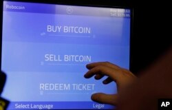 Christopher David uses a Robocoin kiosk to sell bitcoins outside of the 500 Startups’ Bitcoinferance in Mountain View, Calif., March 20, 2014.
