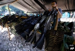 FILE - Weapons belonging to rebels of the Revolutionary Armed Forces of Colombia (FARC) are stored at a rebel camp in La Carmelita near Puerto Asis in Colombia's southwestern state of Putumayo, Feb. 28, 2017.