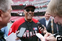 Team World manager Tony Perez talks with the media during batting practice before the All-Star Futures baseball game against Team United States, in Cincinnati, July 12, 2015.