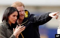 FILE - Britain's Prince Harry and his fiancee, Meghan Markle, attend the UK team trials for the Invictus Games Sydney 2018 at the University of Bath in Bath, England, April 6, 2018.