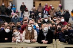 Faithful listen to Pope Francis' message during the Angelus noon prayer in St. Peter's Square, at the Vatican, Jan. 6, 2022.