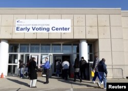 FILE - Voters walk into the Franklin County in-person absentee voting location to cast ballots in Columbus, Ohio, Nov. 5, 2012.