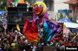 Revellers take part in the annual block party known as "Carmelitas," during carnival festivities in Rio de Janeiro, March 1, 2019.
