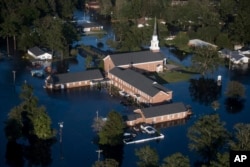 Floodwaters inundate a church after Hurricane Florence struck the Carolinas Monday, Sept. 17, 2018, in Conway, S.C.