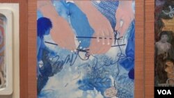 The panel of Kyujin Lee shows hands trying to knit an unruly thread. This, she says, shows her own separation from South Korea and how her life has become knitted into the US. (Jsoh/VOA)