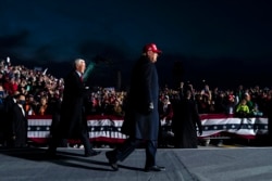 President Donald Trump and Vice President Mike Pence arrive for a campaign rally at Cherry Capital Airport, Monday, Nov. 2, 2020, in Traverse City, Mich. (AP Photo/Evan Vucci)