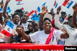 FILE - Supporters of the ruling Rwandan Patriotic Front (RPF) cheer during a rally by Rwandan President Paul Kagame in Nyanza, Rwanda, July 14, 2017.