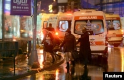 People run away from a nightclub where a gun attack took place during a New Year's Eve party in Istanbul, Turkey, Jan. 1, 2017.