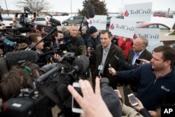 FILE - Members of the media gather around Republican presidential candidate Sen. Ted Cruz of Texas before a campaign event at King's Christian Bookstore in Boone, Iowa, Jan. 4, 2016.