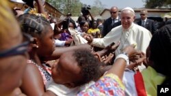 Pope Francis is cheered by locals as he visits a refugee camp, in Bangui, Central African Republic, Nov. 29, 2015.