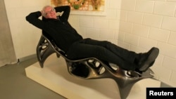 Wilfried Vancraen, chief executive of Materialise, poses for Reuters on a 3D KOL/MAC Root Chair by Sulan Kolatan and William MacDonald, built in one piece on Materialise's Mammoth Stereolithography Machine, in Leuven, January 24, 2013.