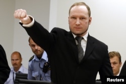 Norwegian mass killer Anders Behring Breivik gestures as he arrives at the court room in Oslo Courthouse August 24, 2012.