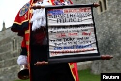 A man makes an announcement outside Windsor Castle that Britain's Meghan, the Duchess of Sussex gave birth to a boy, in Windsor, Britain, May 6, 2019.