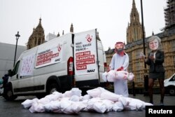 Activists from Avaaz stage a protest timed to coincide with the visit by Saudi Arabia's Crown Prince Mohammad bin Salman outside the Houses of Parliament in London, Britain, March 7, 2018.