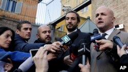 Italian journalists Gianluigi Nuzzi, right, and Emiliano Fittipaldi, talk to reporters outside Vatican City's Perugino gate, Nov. 24, 2015.