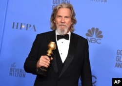 FILE - Jeff Bridges poses in the press room with the Cecil B. DeMille award at the 76th annual Golden Globe Awards in Beverly Hills, Calif., Jan. 6, 2019.