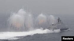 FILE - Flares are set off from a Taiwan navy missile ship in a military drill outside a naval base in Kaohsiung port, southern Taiwan, Jan. 27, 2016.