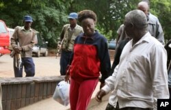 FILE - Zimbabwean human rights activist, Jestina Mukoko (c) is led into court in Harare, Zimbabwe on Dec. 24, 2008.