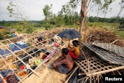 Rohingya refugees sit in front of their house which has been destroyed by Cyclone Mora at the Balukhali Refugee Camp in Cox’s Bazar, Bangladesh May 31, 2017.