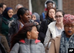 FILE - Brooklyn College students walk across campus for class, in Brooklyn, New York, Feb. 1, 2017.