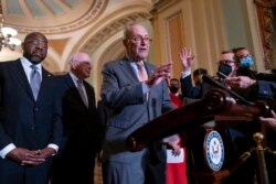 Senate Majority Leader Chuck Schumer, D-N.Y., center, speaks to reporters following a Democratic policy meeting at the Capitol in Washington, Nov. 2, 2021.