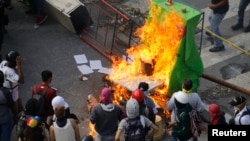 Demonstrators watch a barricade burn after clashes broke out while the Constituent Assembly election is being carried out in Caracas, Venezuela, July 30, 2017.