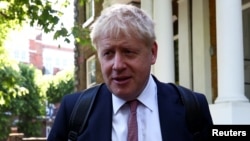 FILE - Former British Foreign Secretary Boris Johnson, who is running to succeed Theresa May as prime minister, leaves his home in London, May 30, 2019.