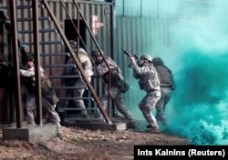 Latvian Army soldiers practice urban fighting during Silver Arrow 2017 multinational military drills involving eleven NATO members in Adazi, Latvia, October 29, 2017.