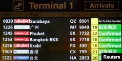 A flight information signboard shows the status of AirAsia flight QZ 8501 from the Indonesian city of Surabaya to Singapore at Changi Airport in Singapore, Dec. 28, 2014.
