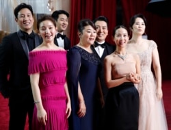 The cast of "Parasite" arrives at the Oscars on Sunday, Feb. 9, 2020, at the Dolby Theatre in Los Angeles. (AP Photo/John Locher)