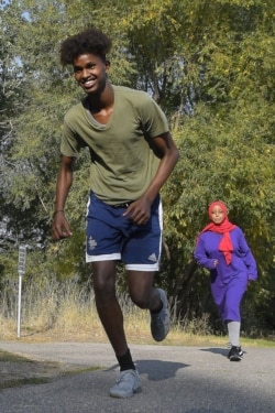Mowlid Nur, left, and Ubah Yusuf go for a run during an Athletics United event in Logan, Utah