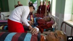 Buddhist monks are treated at a hospital in Monywa after a police crackdown on protesters at a controversial copper mine, Nov. 29, 2012.