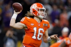 FILE - Clemson quarterback Trevor Lawrence wants to play despite the coronavirus. (AP Photo/Gerald Herbert)