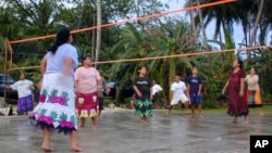 FILE - Women play volleyball April 9, 2004, in Kosrae, Micronesia. (AP Photo/Charles Hanley)
