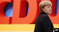German Chancellor Angela Merkel walks during a convention of the Christian Democratic Union in Karlsruhe, Germany, Dec. 14, 2015.