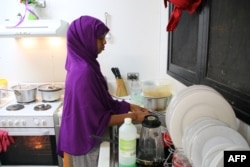 FILE - A refugee from Somalia, who had attempted suicide, is seen doing kitchen chores at Camp Five on the Pacific island of Nauru, Sept. 2, 2018.