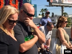 Grief-stricken people come to pay respects to mass shooting victims at a make-shift memorial in Las Vegas, Nevada, Oct. 6, 2017. (Photo: C. Presutti / VOA)