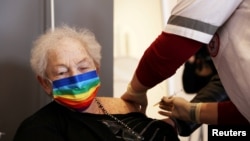 FILE - A elderly woman receives a booster shot of her vaccination against the coronavirus disease (COVID-19) at an assisted living facility, in Netanya, Israel January 19, 2021. (REUTERS/Ronen Zvulun/File Photo)