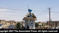 A Taliban flag flies in the square of Ghazni city after fighting between Taliban and Afghan security forces in Ghazni, southwest of Kabul, Afghanistan, Thursday, Aug. 12, 2021. The Taliban captured the provincial capital near Kabul on Thursday, the…