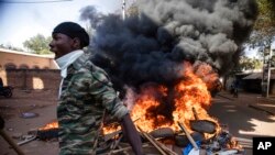 FILE - Protesters take to the streets of Burkina Faso's capital, Ouagadougou, Nov. 27, 2021, calling for President Roch Marc Christian Kabore to resign. 