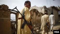 Laskar Taliban berpatroli di sebuah distrik yang terkena serangan udara di Pakistan (foto: dok).
