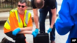 In this undated photo provided by Biobot in June 2020 technicians take a sewage sample. Across the U.S. and in Europe, researchers and health officials say they can track the course of a community outbreak by studying the waste flushed from its bathrooms.