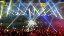 A crowd attending a soccer game in Istanbul, Turkey, watches a laser light show.