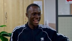 Souleymane Fofana jokes with friends at the Belleville community center. (Lisa Bryant/VOA)