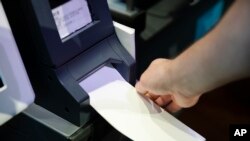Steve Marcinkus, an Investigator with the Office of the City Commissioners, demonstrates the ExpressVote XL voting machine at the Reading Terminal Market in Philadelphia, June 13, 2019.