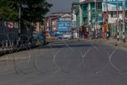 A barbwire blocks a deserted street on the first anniversary of India’s decision to revoke the disputed region’s semi-autonomy, in Srinagar, Indian controlled Kashmir, Aug. 5, 2020.