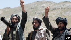 FILE - In this May 27, 2016, photo, Taliban fighters react to a speech by their senior leader in the Shindand district of Herat province, Afghanistan.