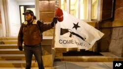 Kem Regik, of Virginia, stands on the sidewalk before a pro gun rally, Jan. 20, 2020, in Richmond, Va. 