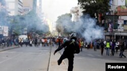 Riot policemen fire teargas a canister to disperse supporters of Kenyan opposition 